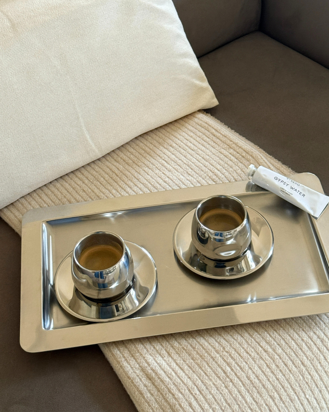 2 amc art design coffee cups on a tray on a blanket