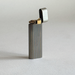 Collectible Cartier Gun à Lignes table lighter, silver stainless steel with gold-plated ribbing