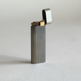 Collectible Cartier Gun à Lignes table lighter, silver stainless steel with gold-plated ribbing