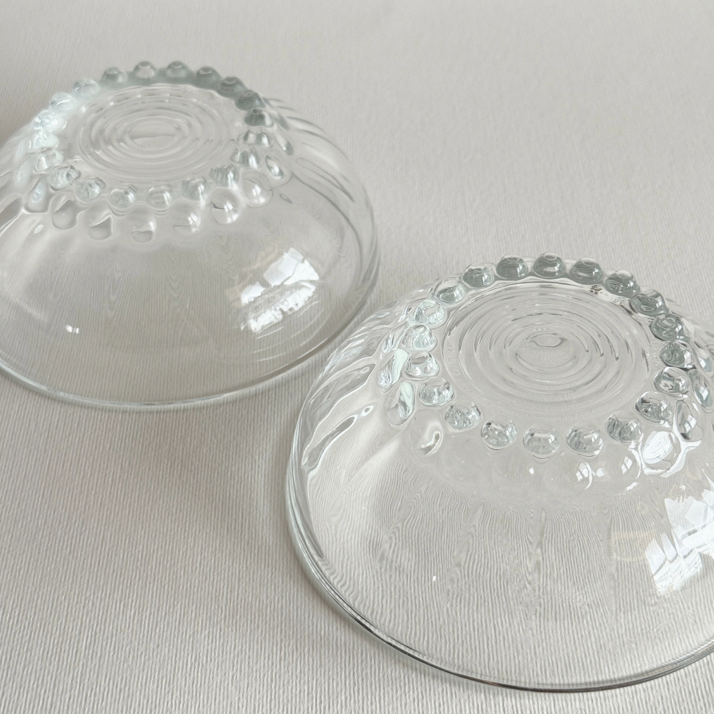 Set of 2 clear mid-century pressed glass bowls with bubble feet and round rims from Reims, France