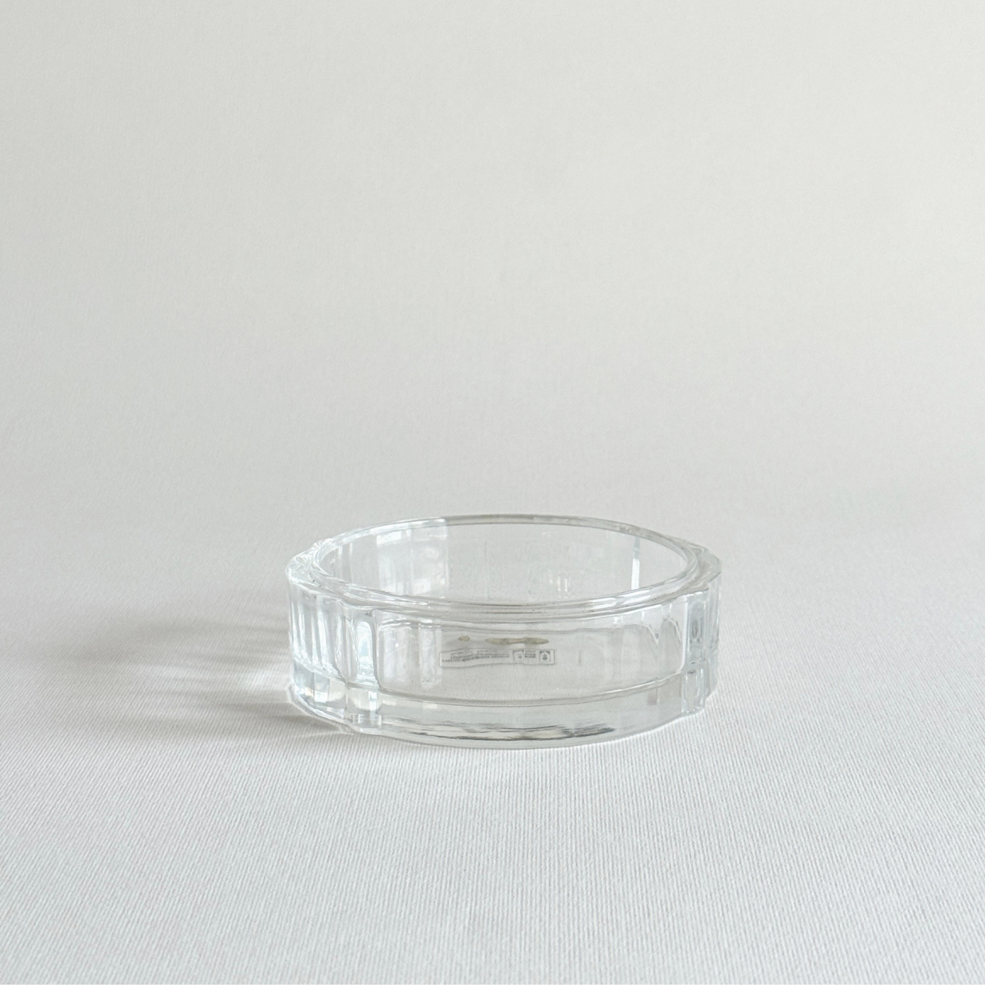 Florentine cut crystal ashtray with ribbed edge, catching the light around the rim