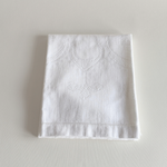 Close view of the hand-stitched embroidered motif on the cotton towel