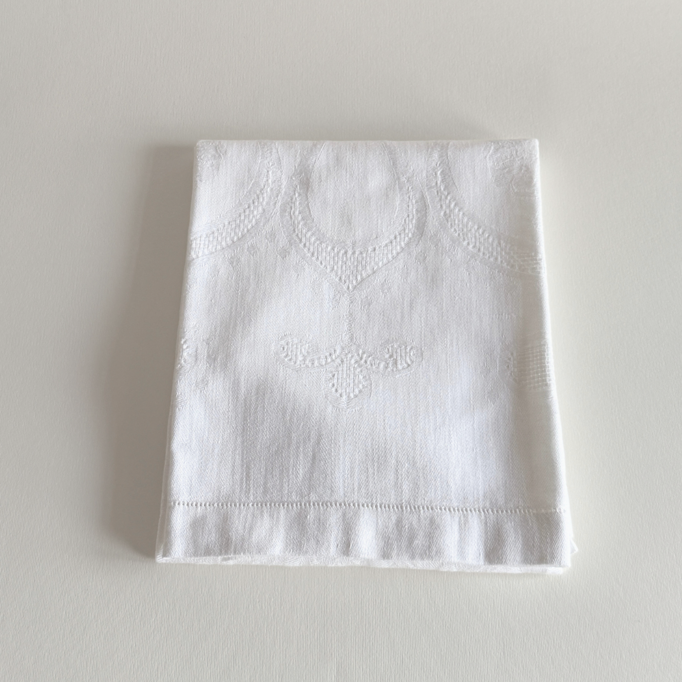 Close view of the hand-stitched embroidered motif on the cotton towel