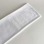 Embroidered cotton hand towel folded, showing the soft weave