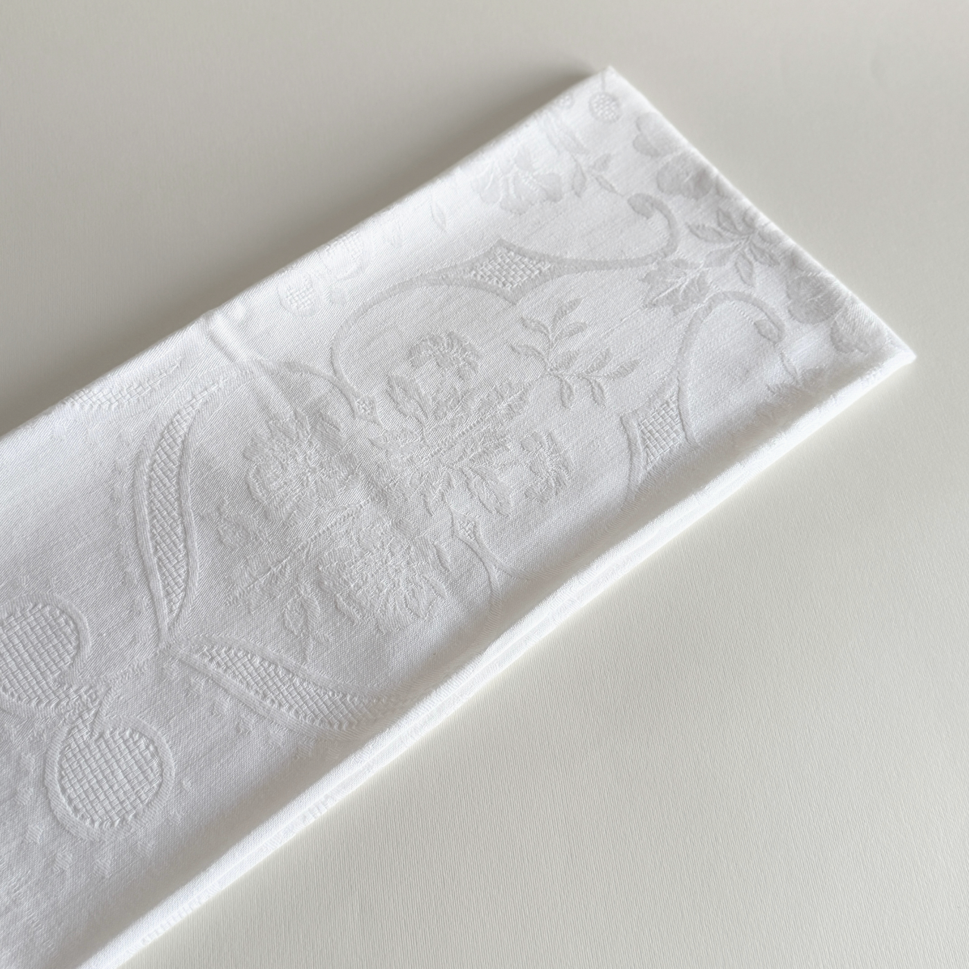 Embroidered cotton hand towel folded, showing the soft weave