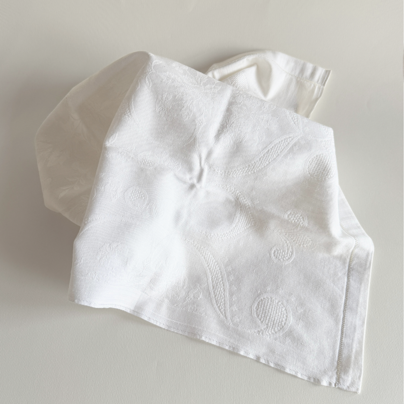 Vintage Italian embroidered cotton towel draped over a rail