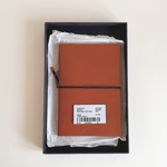 Prada burnt orange Saffiano leather notebook, A5 format with signature diagonal cross-hatch texture