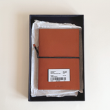 Prada burnt orange Saffiano leather notebook, A5 format with signature diagonal cross-hatch texture