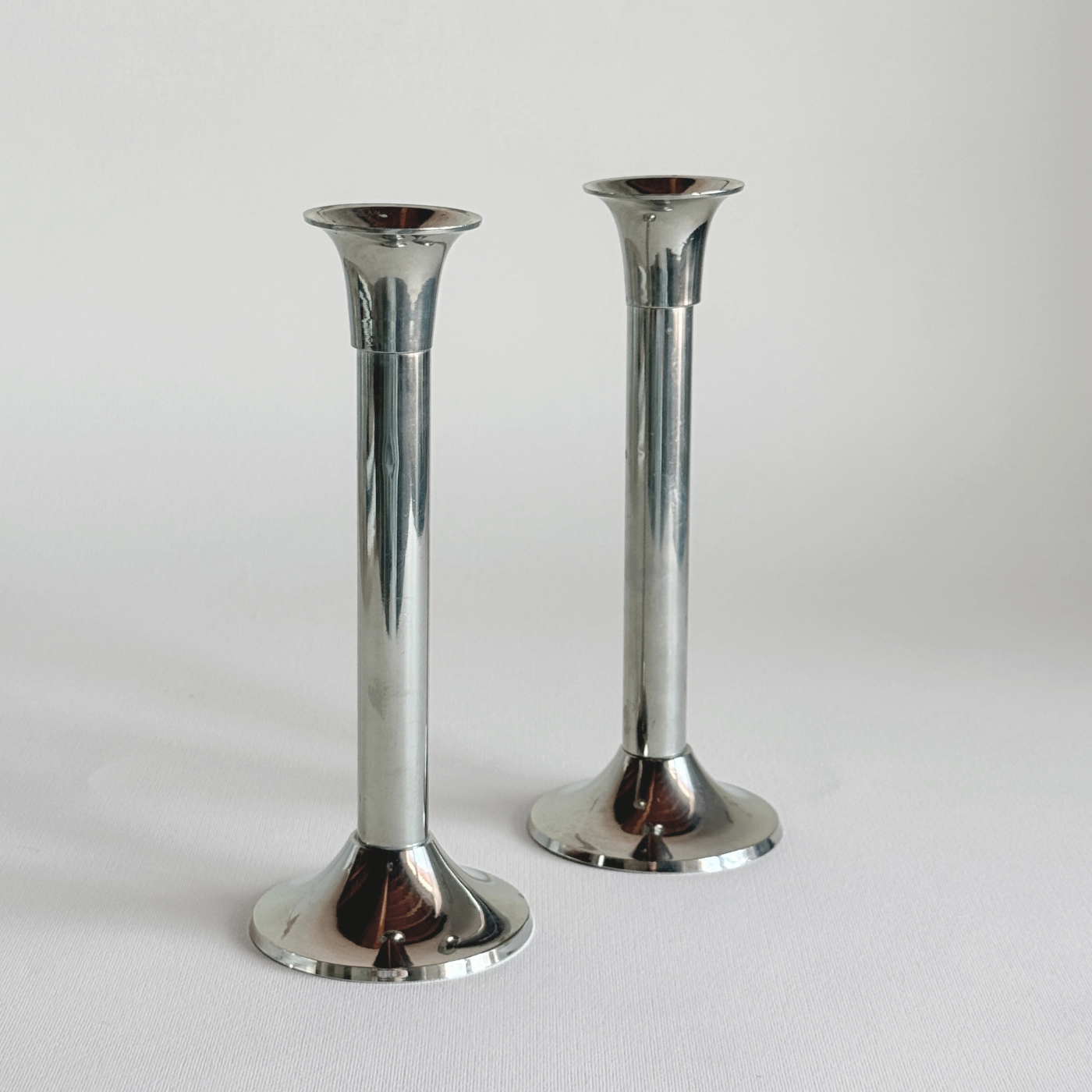 Polished stainless steel candle holder detail, plain bobeche and steel column, L'Officina General Store