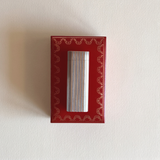 Les Must de Cartier table lighter in silver stainless steel with gold-plated ribbed stripe detail