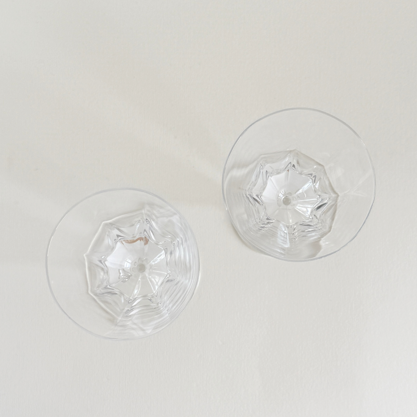 Pair of clear crystal wine glasses with eight faceted sides forming a flower silhouette, Czechia 1980s