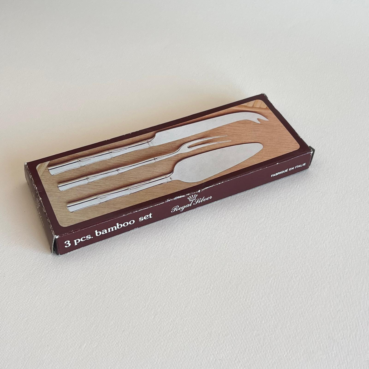 Silver cheese knife, fork and server laid flat, silver-plated bamboo-motif cutlery set from Italy