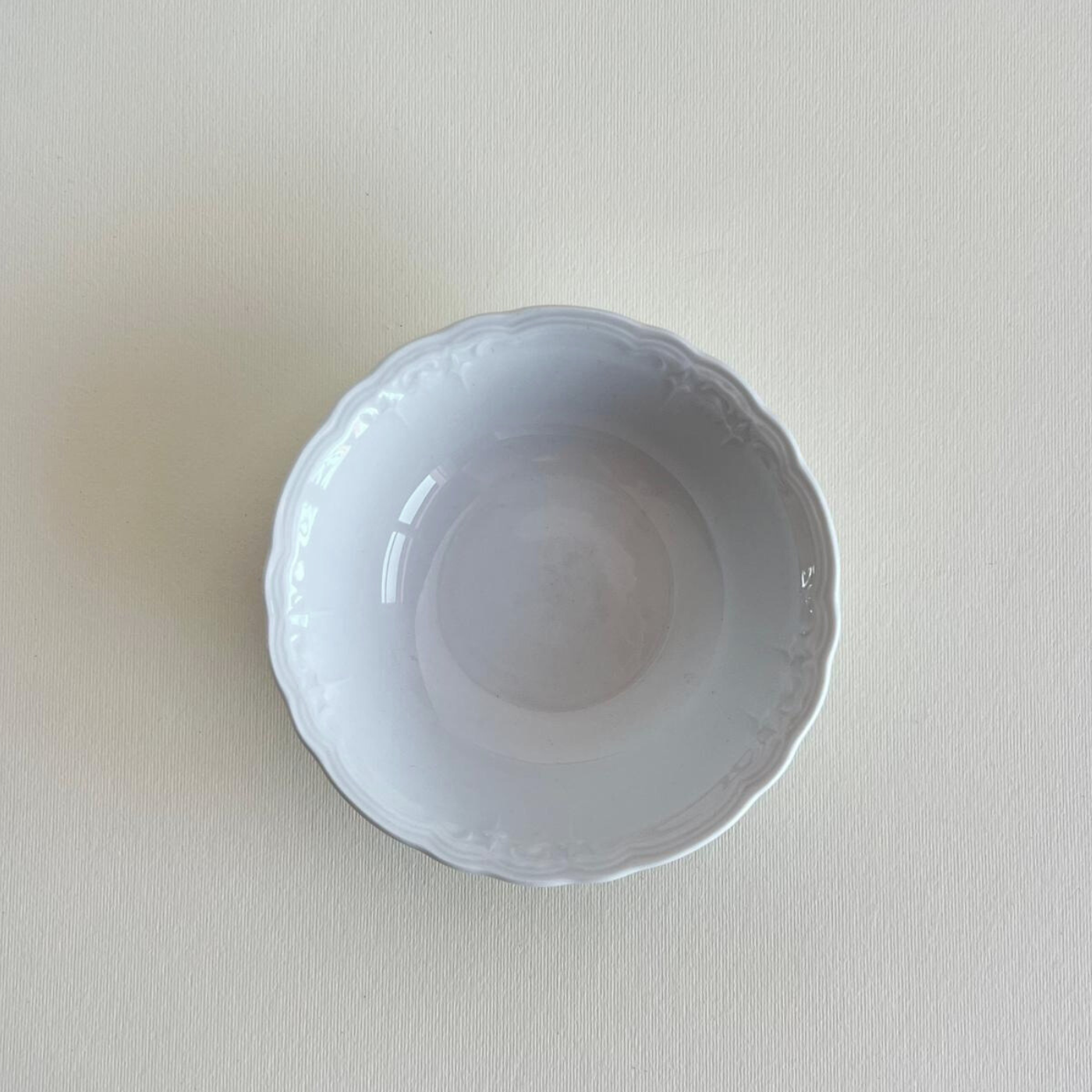 Close-up of Fleur de Lis design on 13 cm white porcelain bowl