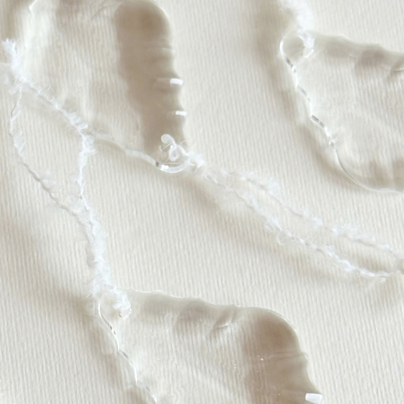 Glass Leaf Prism Christmas Ornament set of two, clear faceted glass leaf drops with soft white hanging cords.