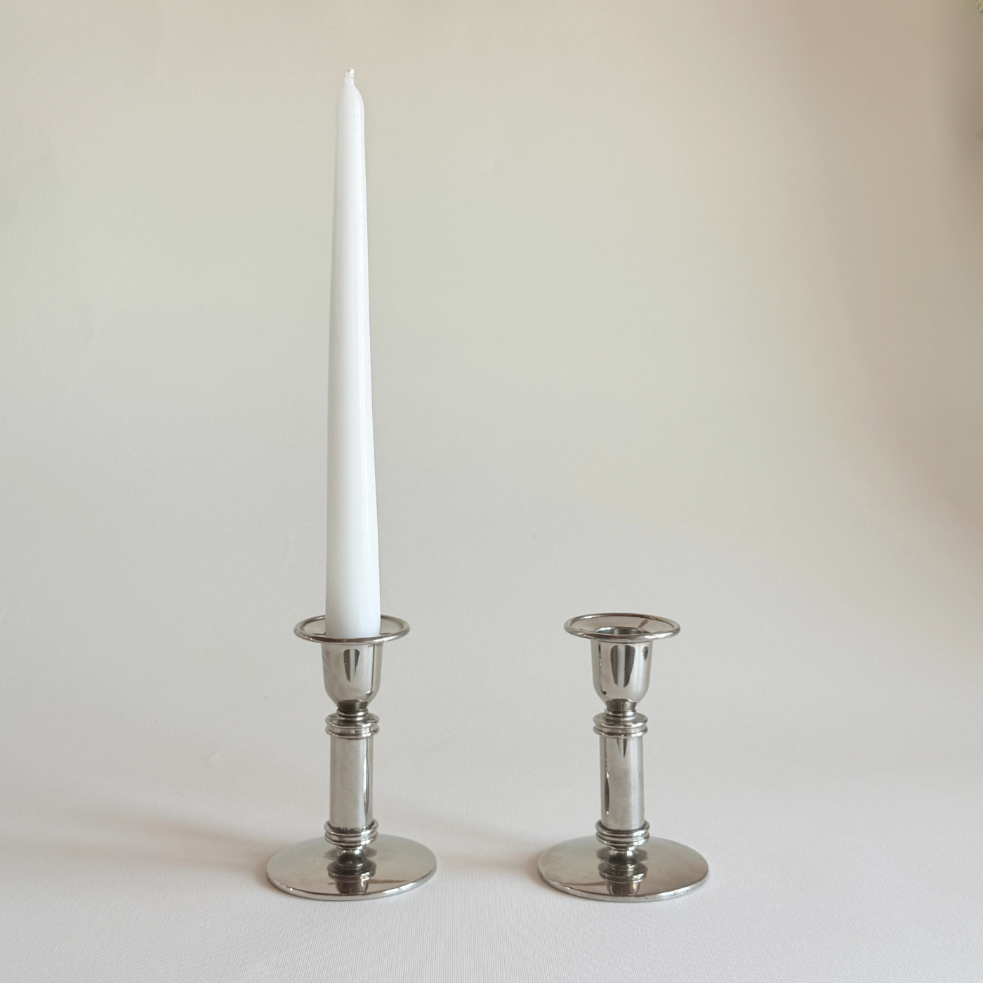 Polished stainless steel candle holders, pair of 1970s French cylinders, L'Officina General Store