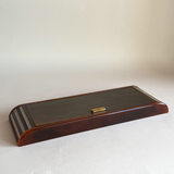 Tortoiseshell Lucite games set open, showing two card decks, poker dice and ivory and brown chips