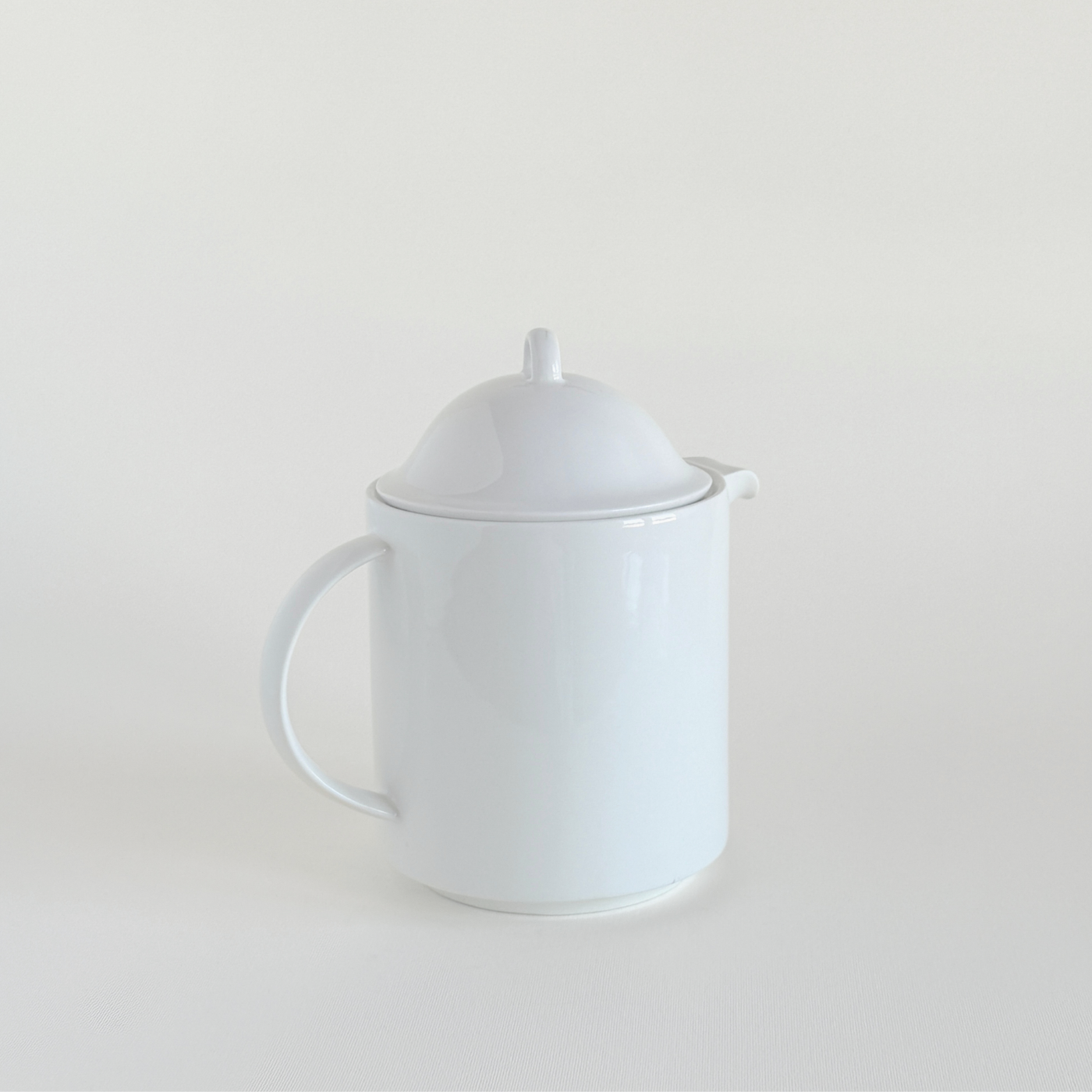 White ceramic teapot · spout detail · minimalist lion motif · L'Officina General Store
