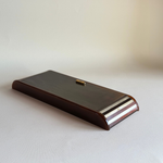 White Lucite mother-of-pearl inset panel on the side of a brown tortoiseshell Romagnoli games case