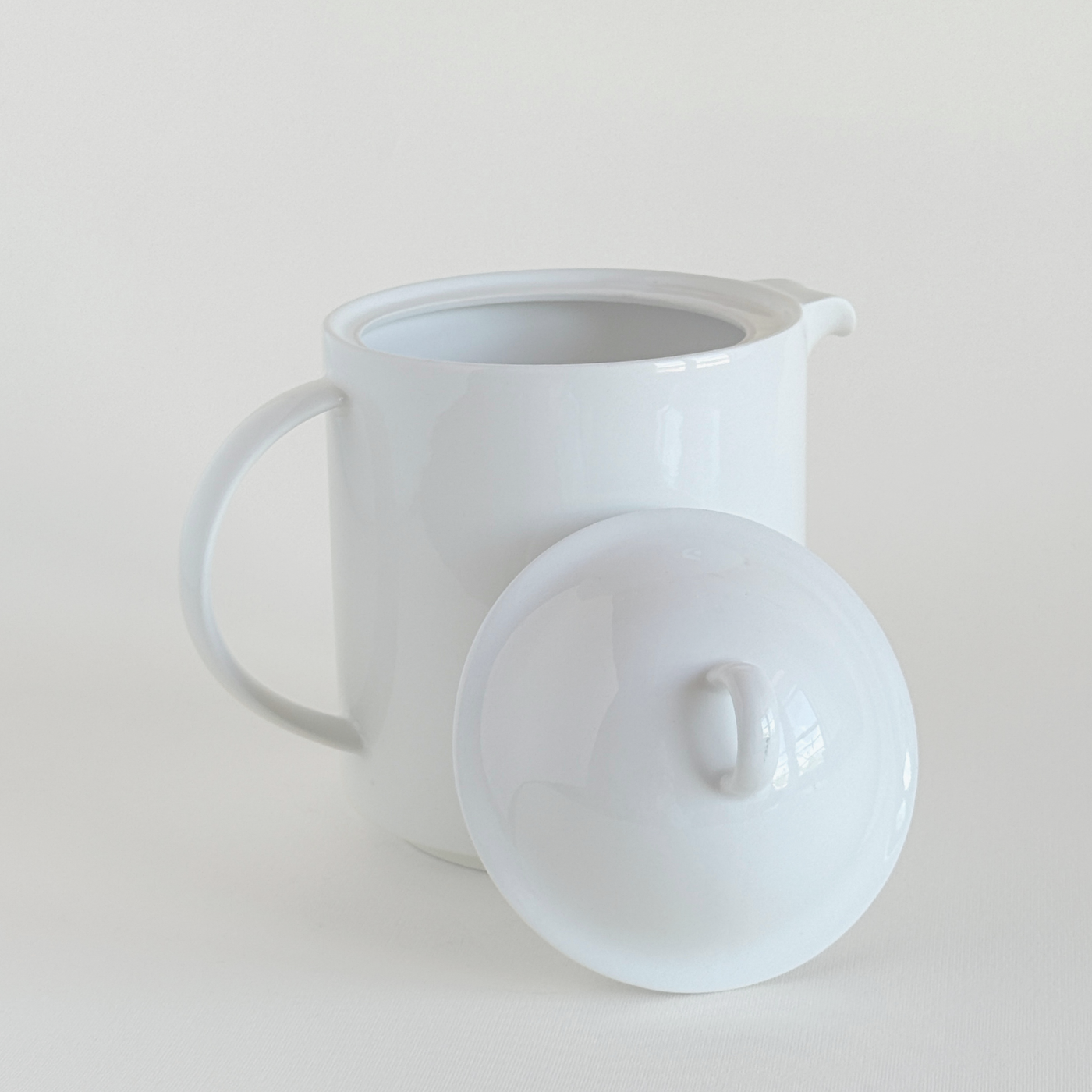 White ceramic teapot · side view · black staining marks shown · L'Officina General Store