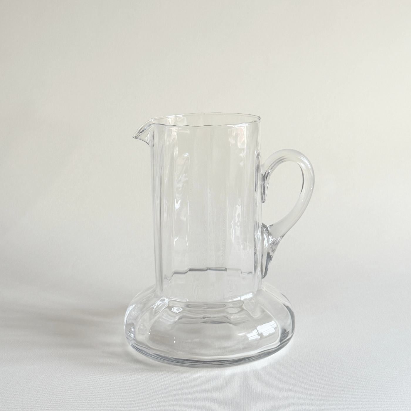 Handblown glass carafe in profile, flared neck opening the form