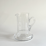 Handblown glass carafe in profile, flared neck opening the form