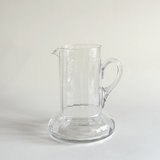 Handblown glass carafe in profile, flared neck opening the form