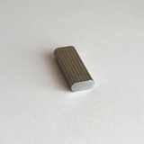 Gold-plated stripe detail on a silver stainless steel Les Must de Cartier table lighter, close view