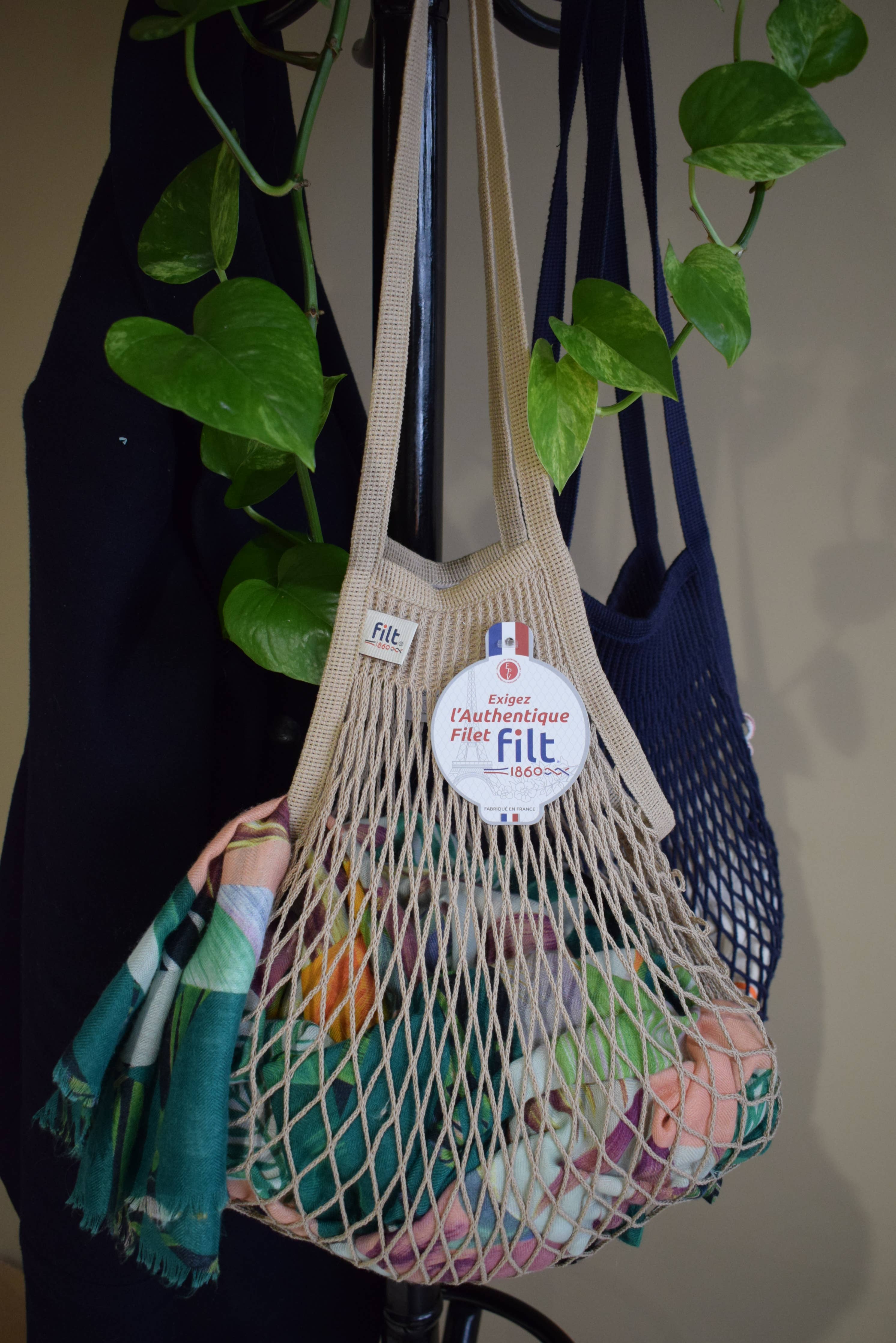 Close detail of mastic knitted cotton mesh and braided handle on a Filt 1860 French net bag