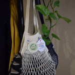 Close detail of ecru knitted cotton mesh and braided handle on a Filt 1860 French net bag