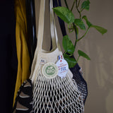 Close detail of ecru knitted cotton mesh and braided handle on a Filt 1860 French net bag