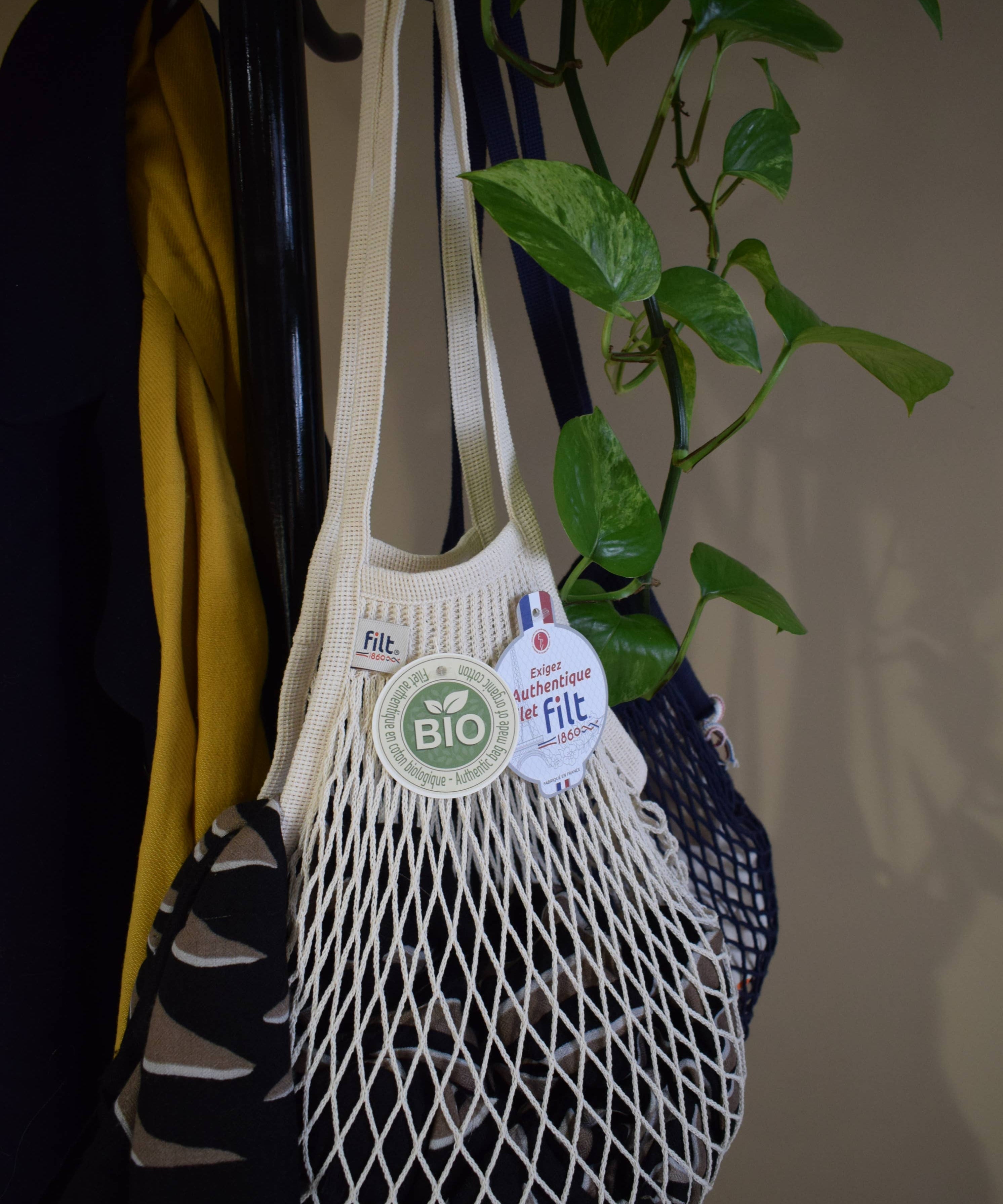 Close detail of ecru knitted cotton mesh and braided handle on a Filt 1860 French net bag