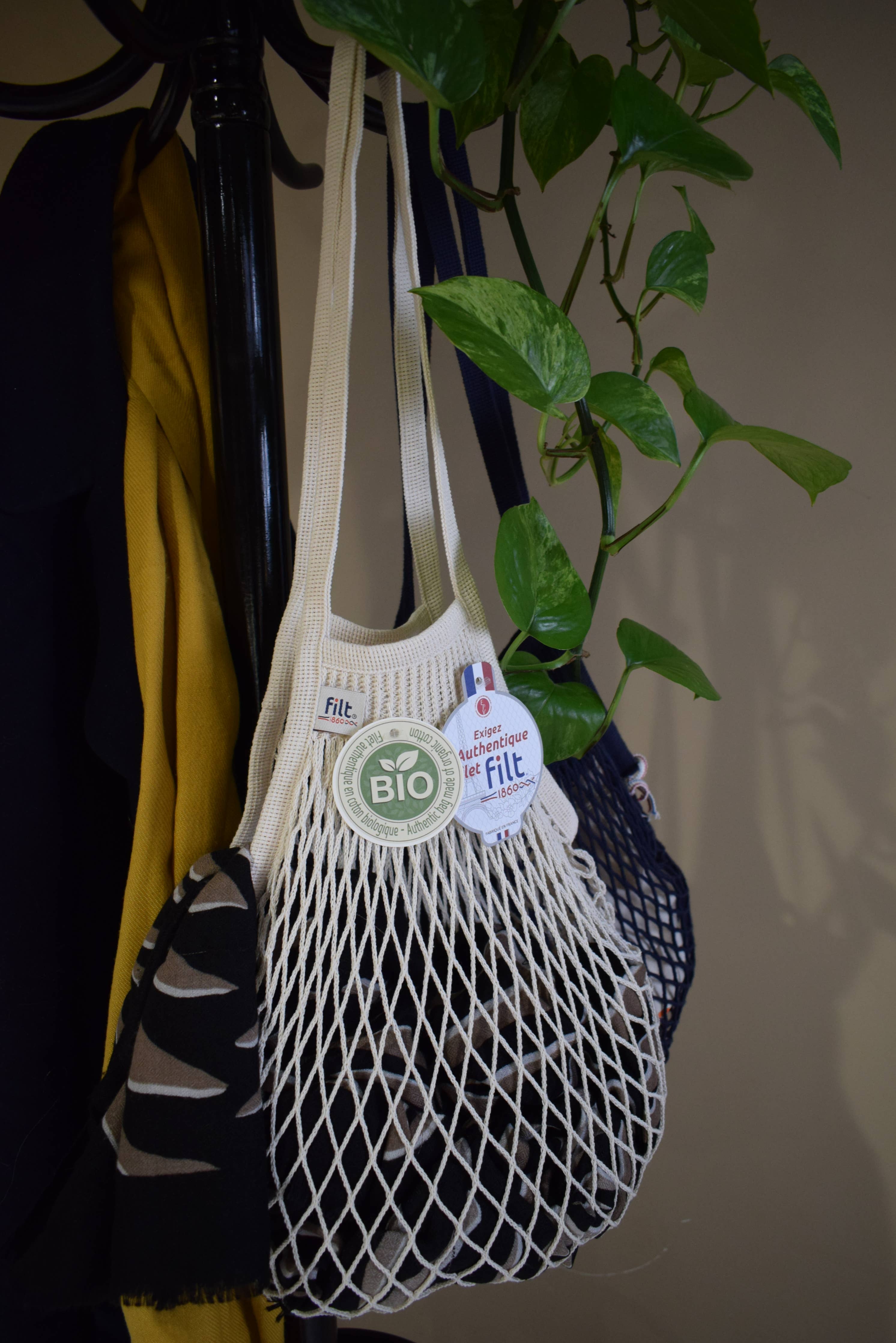 Close detail of ecru knitted cotton mesh and braided handle on a Filt 1860 French net bag