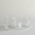 Set of two ribbed crystal tumblers side by side on a neutral surface