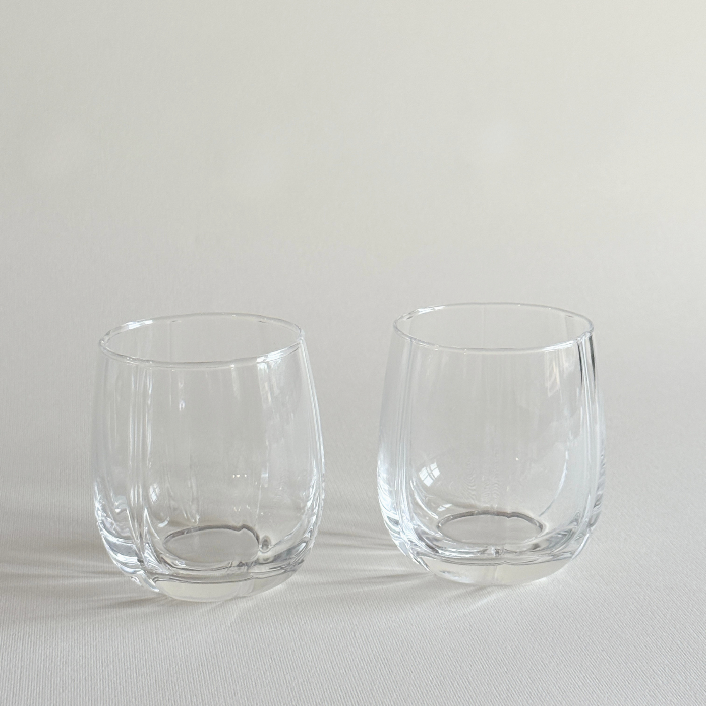 Set of two ribbed crystal tumblers side by side on a neutral surface