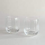 Pair of ribbed crystal tumblers with vertical fluting catching the light
