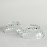 Set of 2 clear pressed glass bowls with bubble feet and round rims, mid-20th century French design from Reims, ideal for desserts or condiments.
