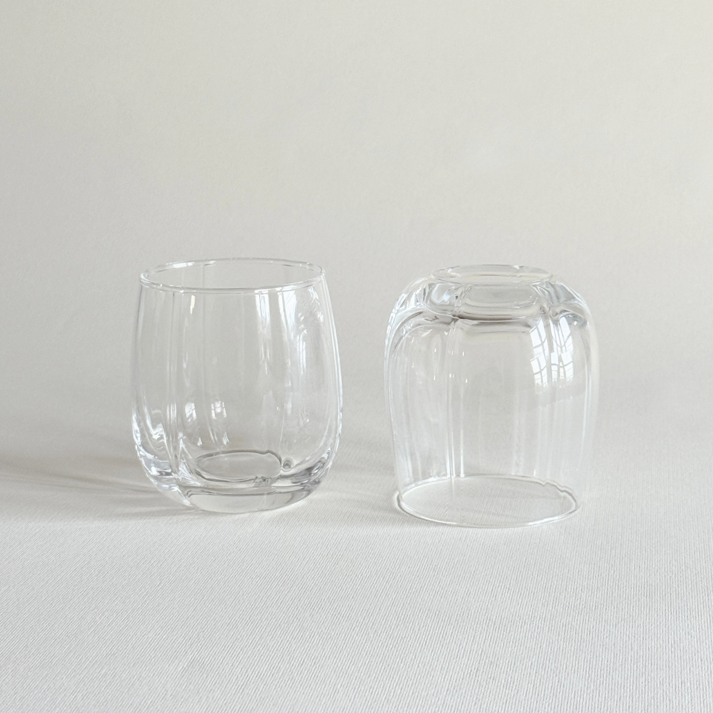 Ribbed crystal tumbler held in the hand, showing the grip of the fluting