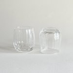Ribbed crystal tumbler held in the hand, showing the grip of the fluting