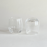 Ribbed crystal tumbler held in the hand, showing the grip of the fluting