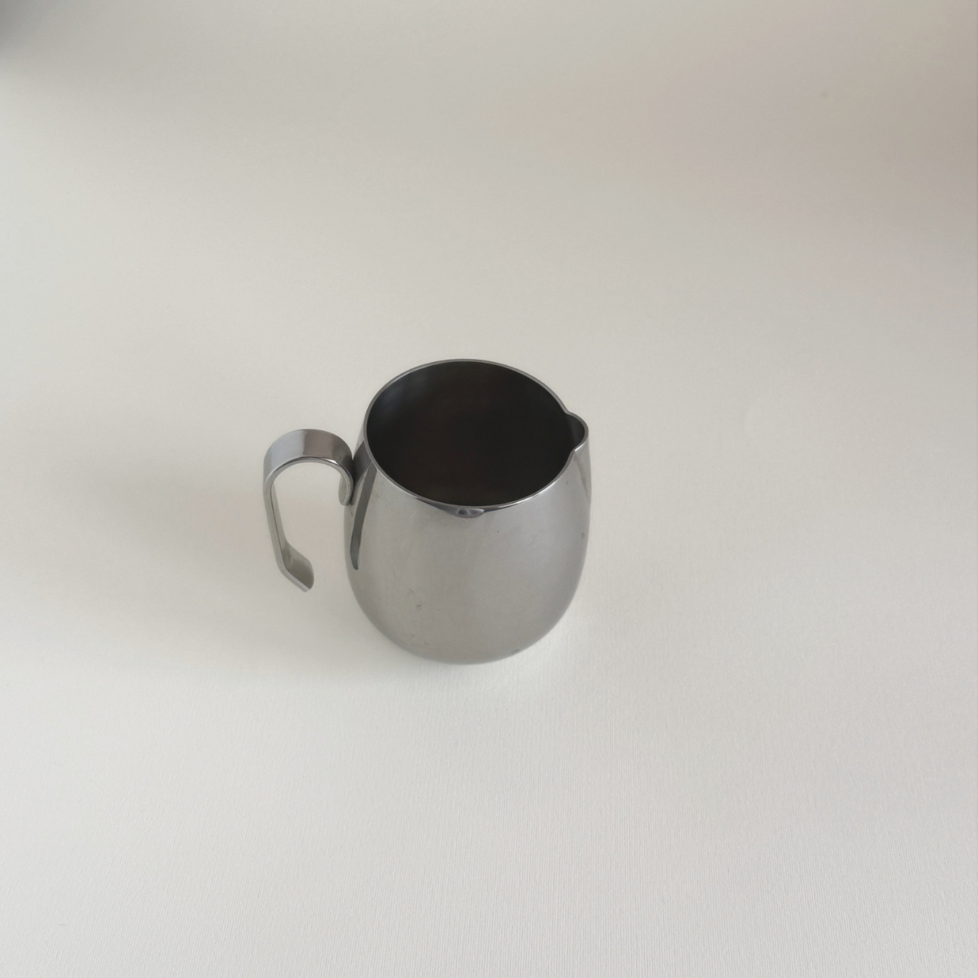 Vintage IMCO stainless steel creamer jug, side view