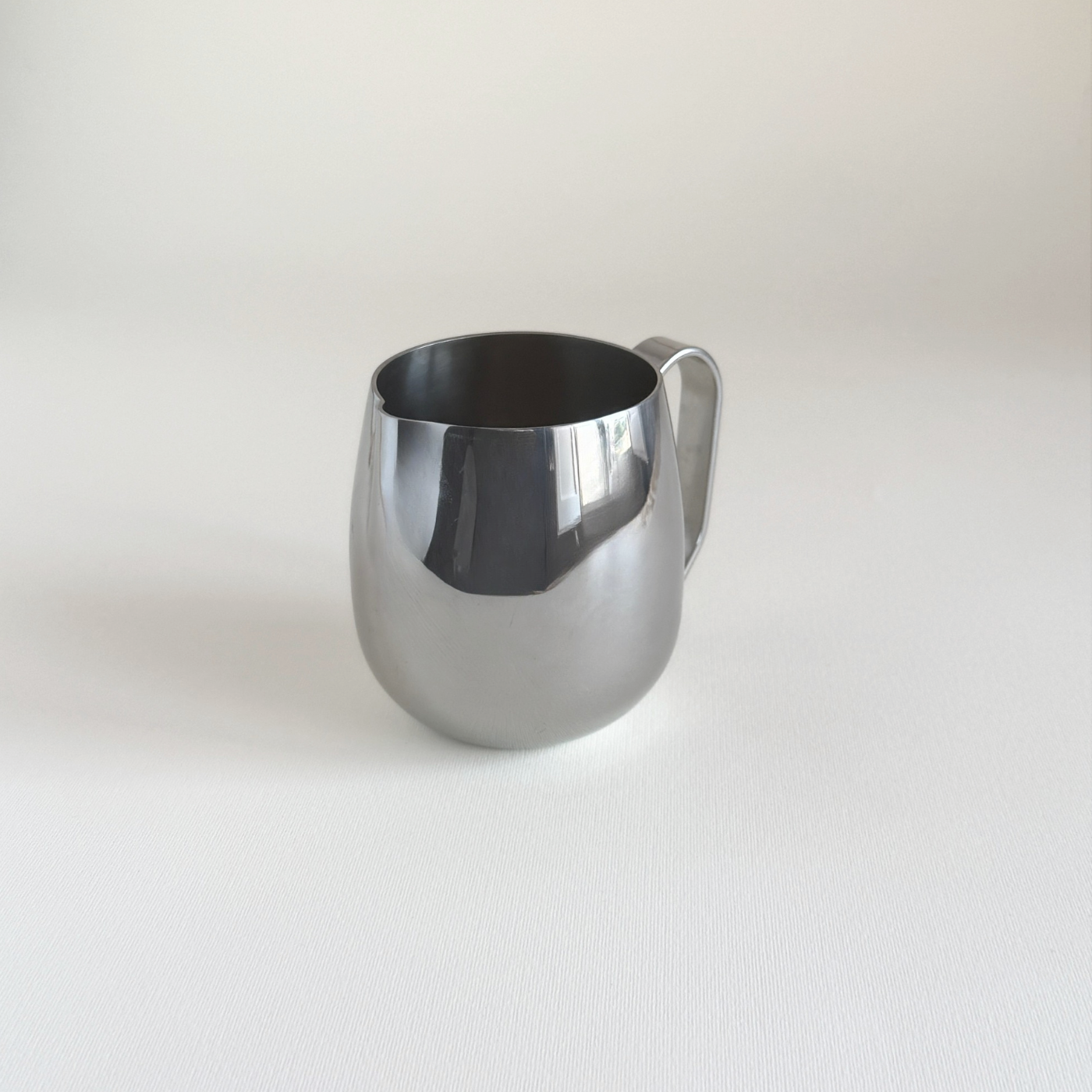 IMCO 1970s Italian creamer in polished steel, pouring lip detail