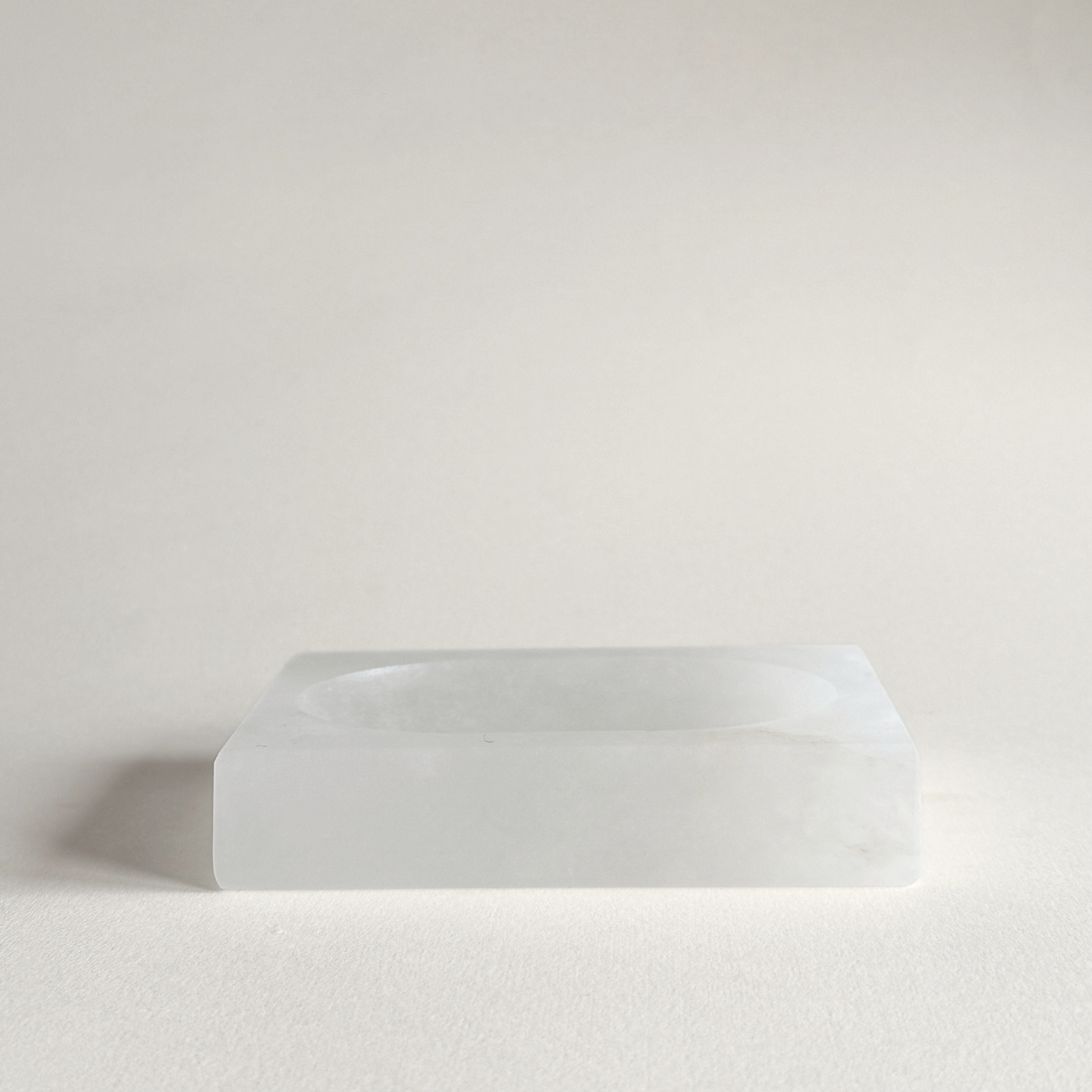 White alabaster soap dish styled on minimalist bathroom sink