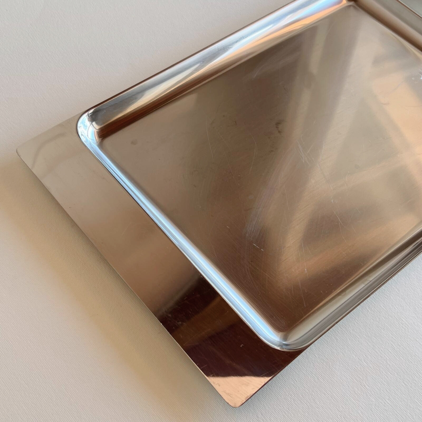 Close-up of Alessi inox tray showing fine micro-scratches