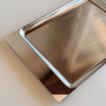 Close-up of Alessi inox tray showing fine micro-scratches