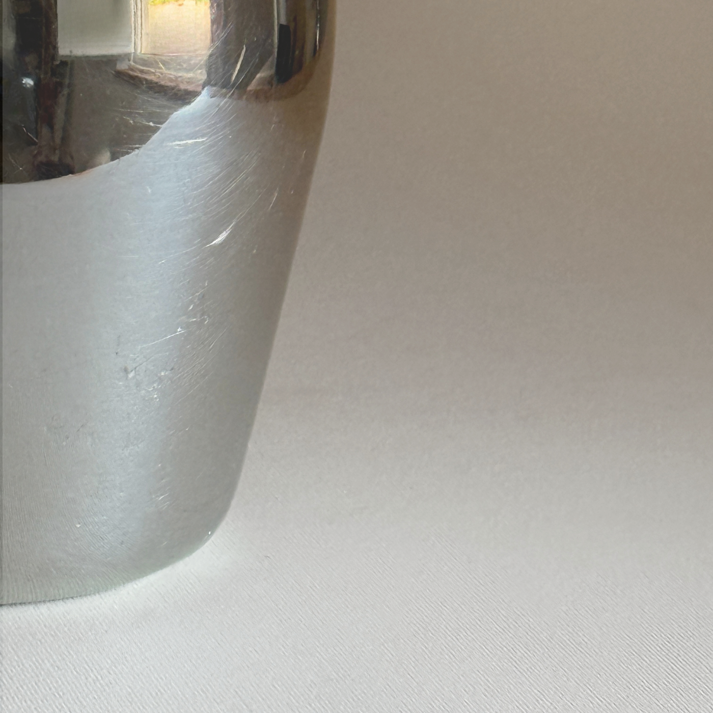 Alessi 871 Ice Bucket in mirror-polished stainless steel with a smooth cylindrical shape and reflective surface detail.