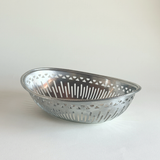 Brushed stainless steel Alessi bread basket in silver, Mercurio design with fine linear texture
