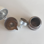 Interior of aluminium moka pot with replaced filter and gasket