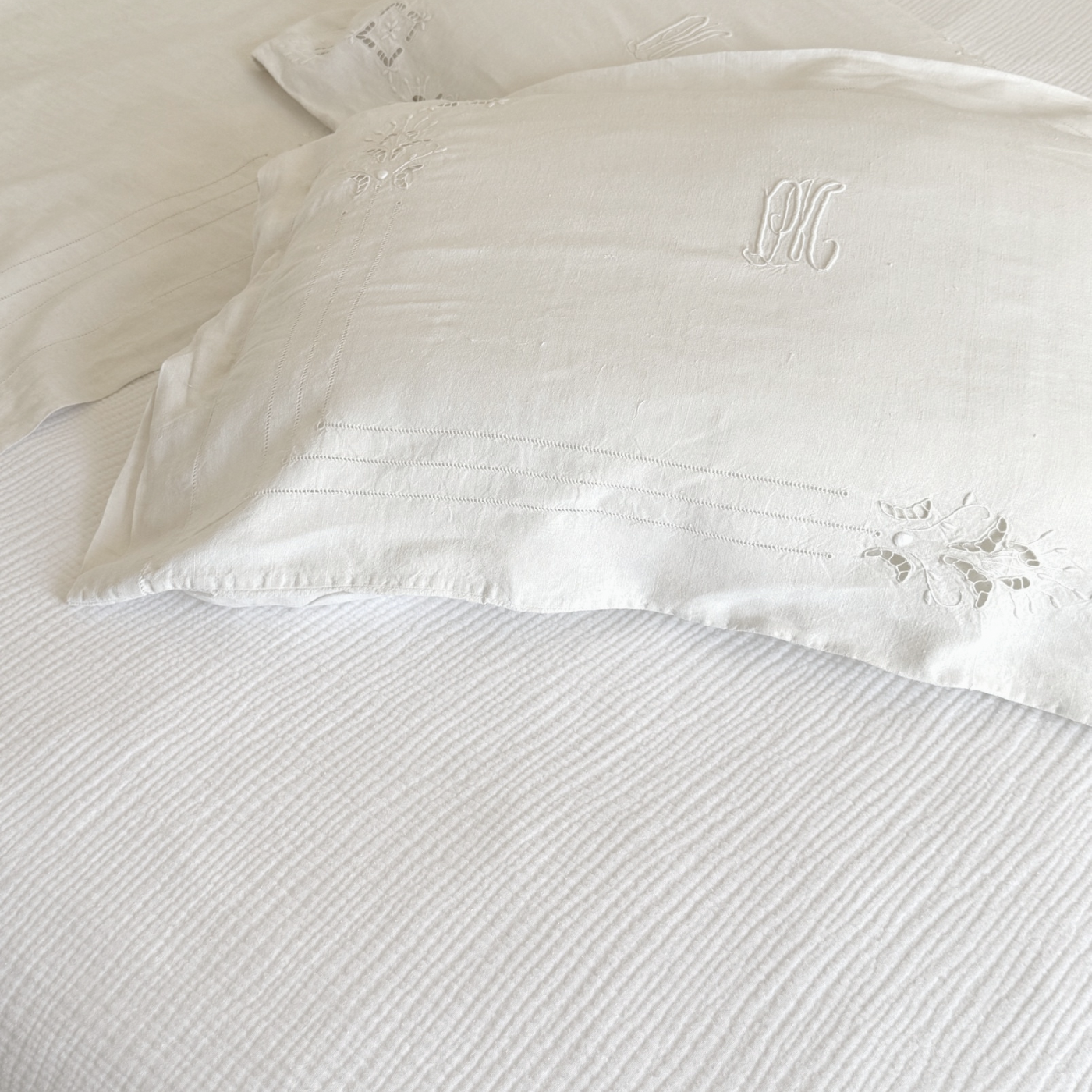 Close-up of structured early 20th century linen weave in neutral bedroom styling