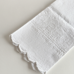 Close view of the floral and fleur-de-lys jacquard weave on the cotton towel