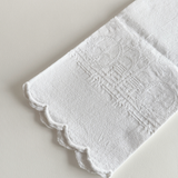 Close view of the floral and fleur-de-lys jacquard weave on the cotton towel